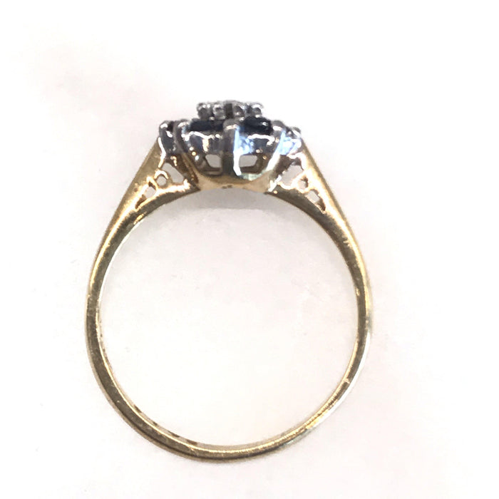 Vintage gold band ring with a sapphire and diamond cluster 